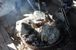 Grilling local sausages over open fire